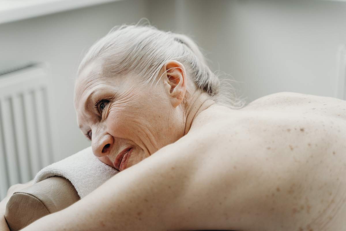 Photo of an Elderly Woman Lying on a Massage Table